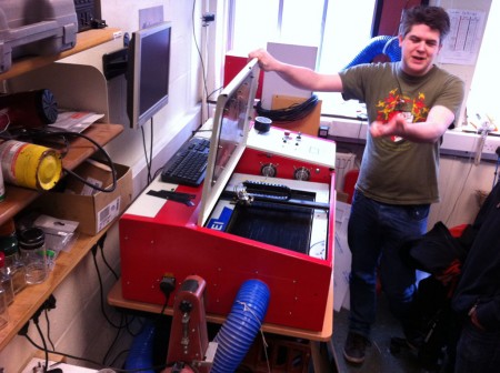 Ted explains to the Software Society how to operate the laser cutter with the lid open.