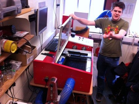 Ted explains to the Software Society how to operate the laser cutter with the lid open.