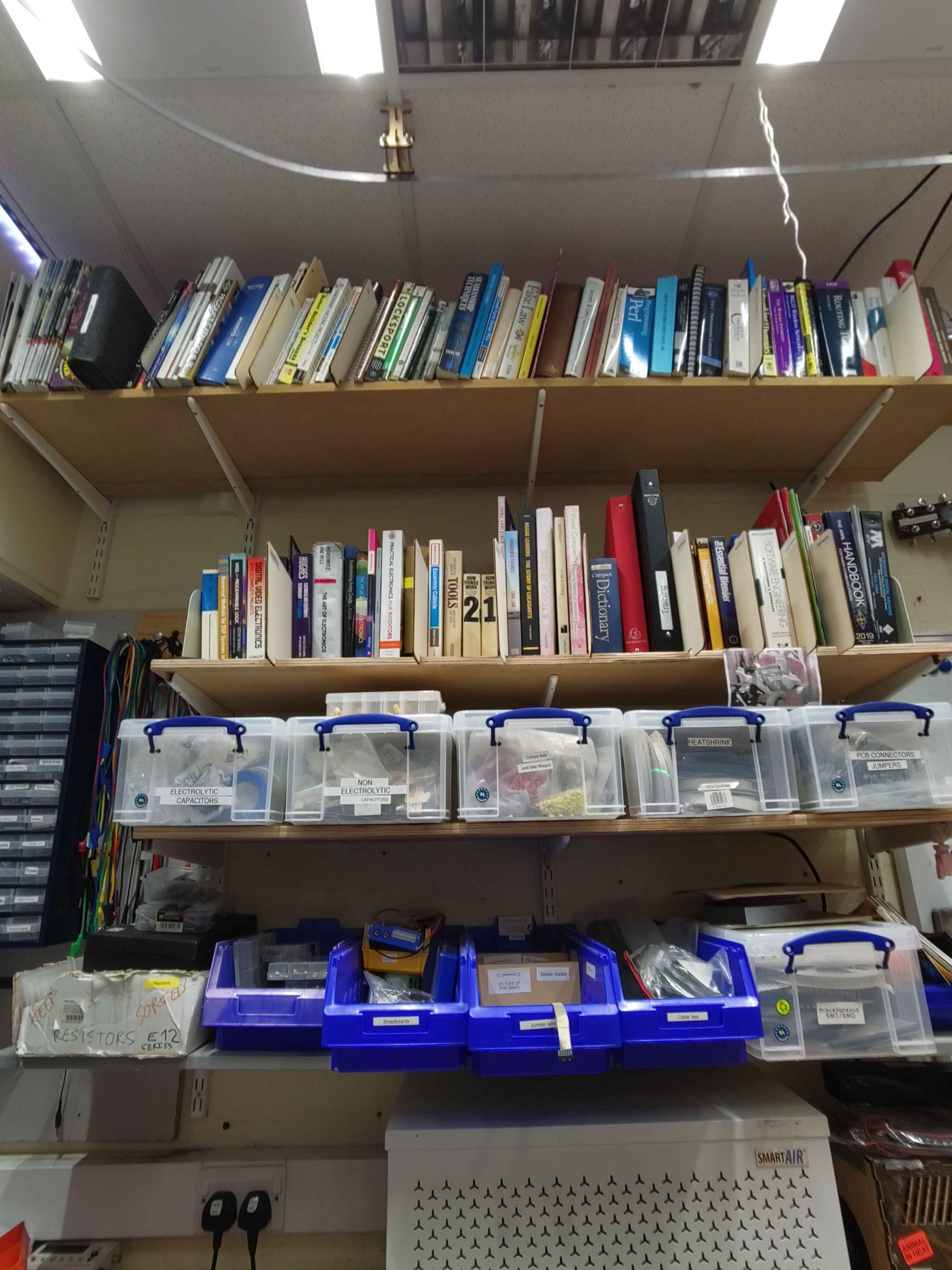 A bookshelf filled with various technical books.